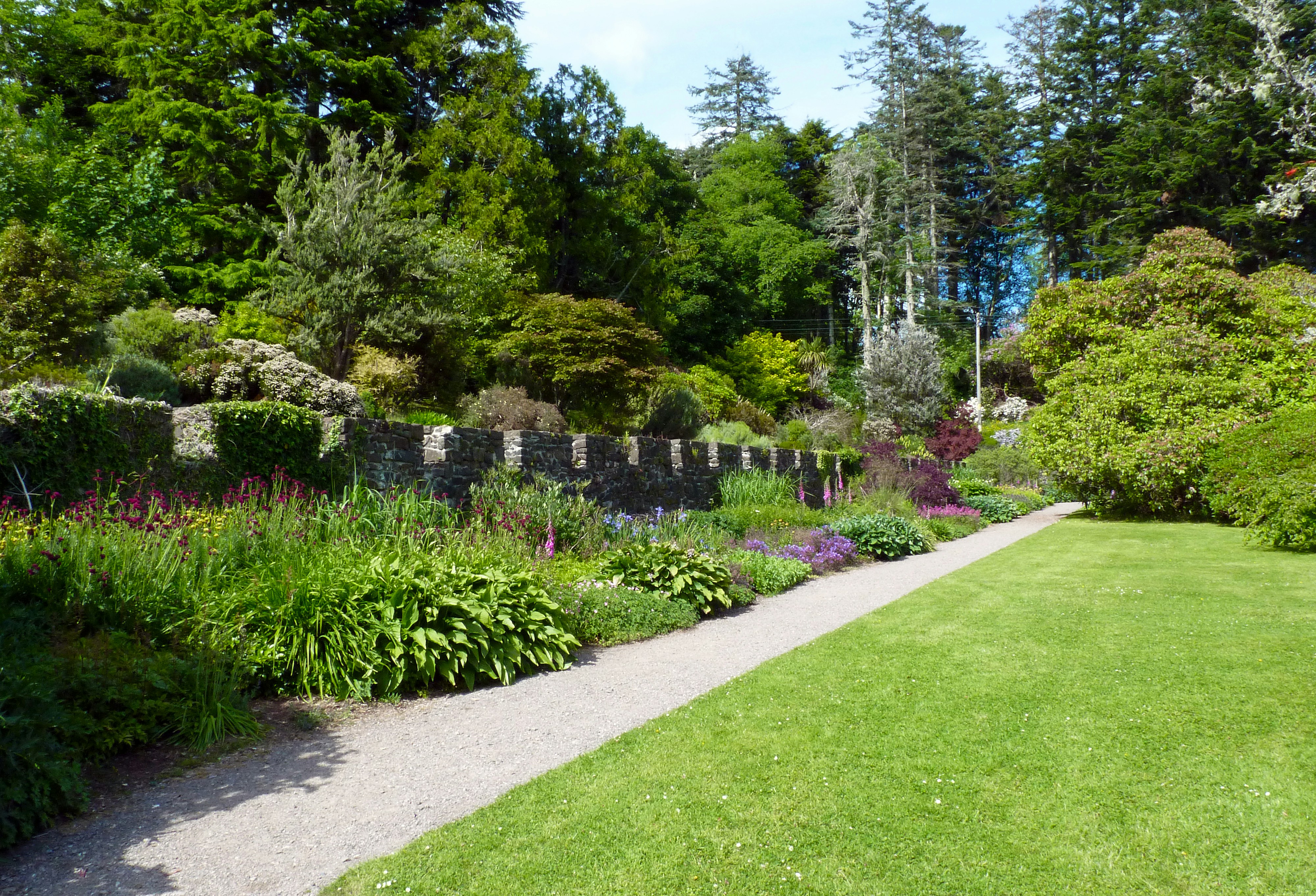 Garden seating area framed by layered plantings